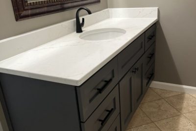 Sleek wooden bathroom cabinet with white countertop and sink