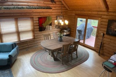 Cozy log cabin dining area with round table