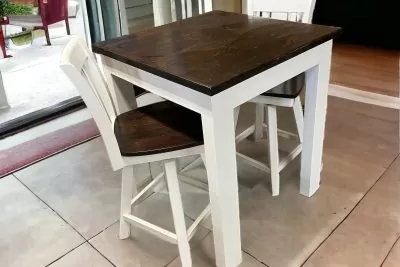 Compact white and dark wood kitchen table with chairs.