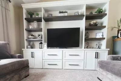 Spacious living room with a white entertainment center and a TV