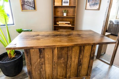 Rustic wooden bar behind dark stained