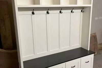 White Hall Tree with black shelf and coat hooks in an empty room