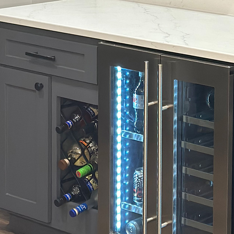 Wine cooler built into gray kitchen cabinetry