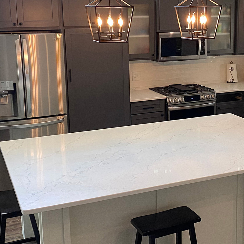 Close-up of a kitchen island with white marble countertop